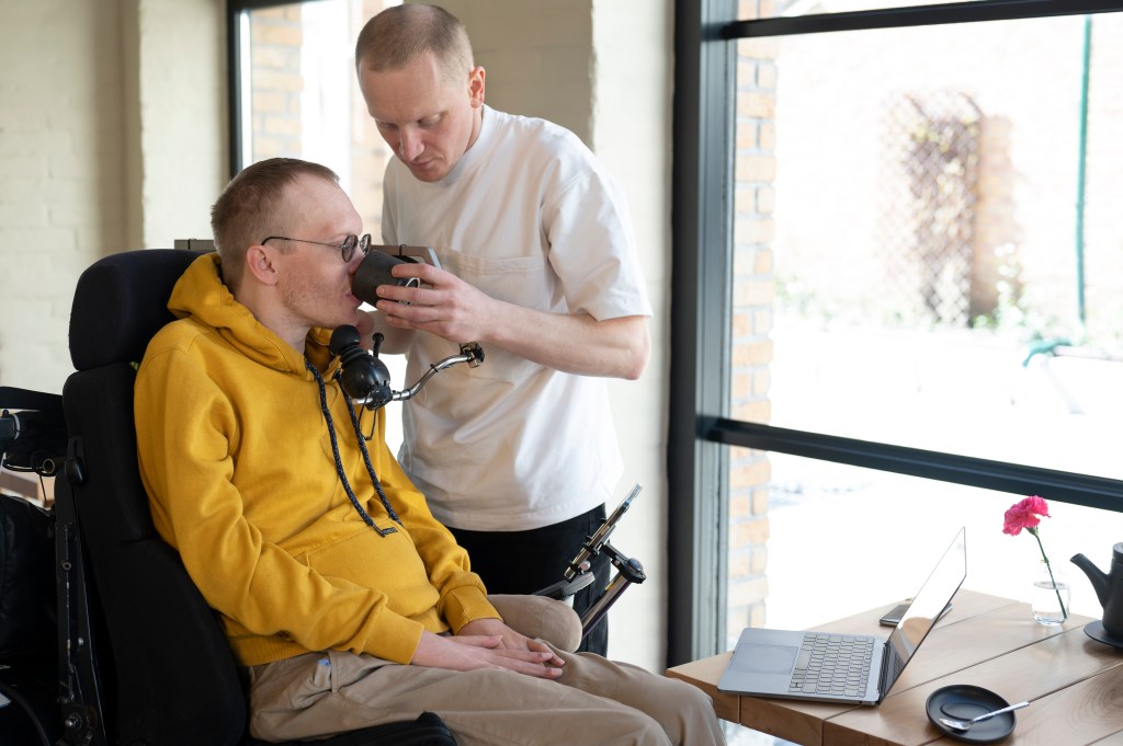 caregiver helping a person with disability