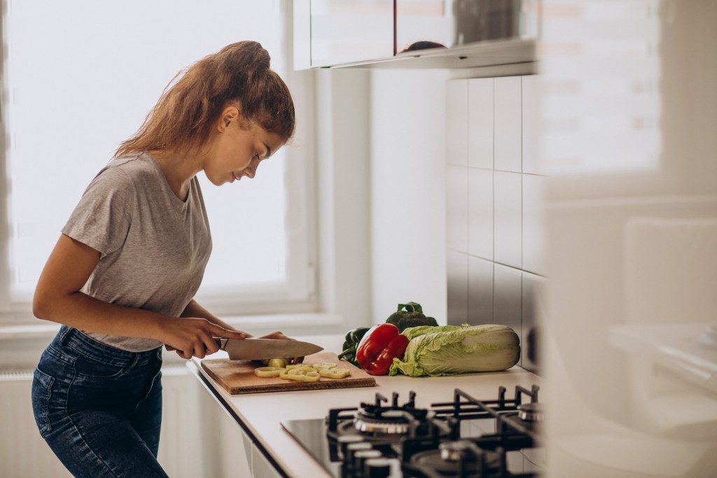 caregiver preparing meal in house